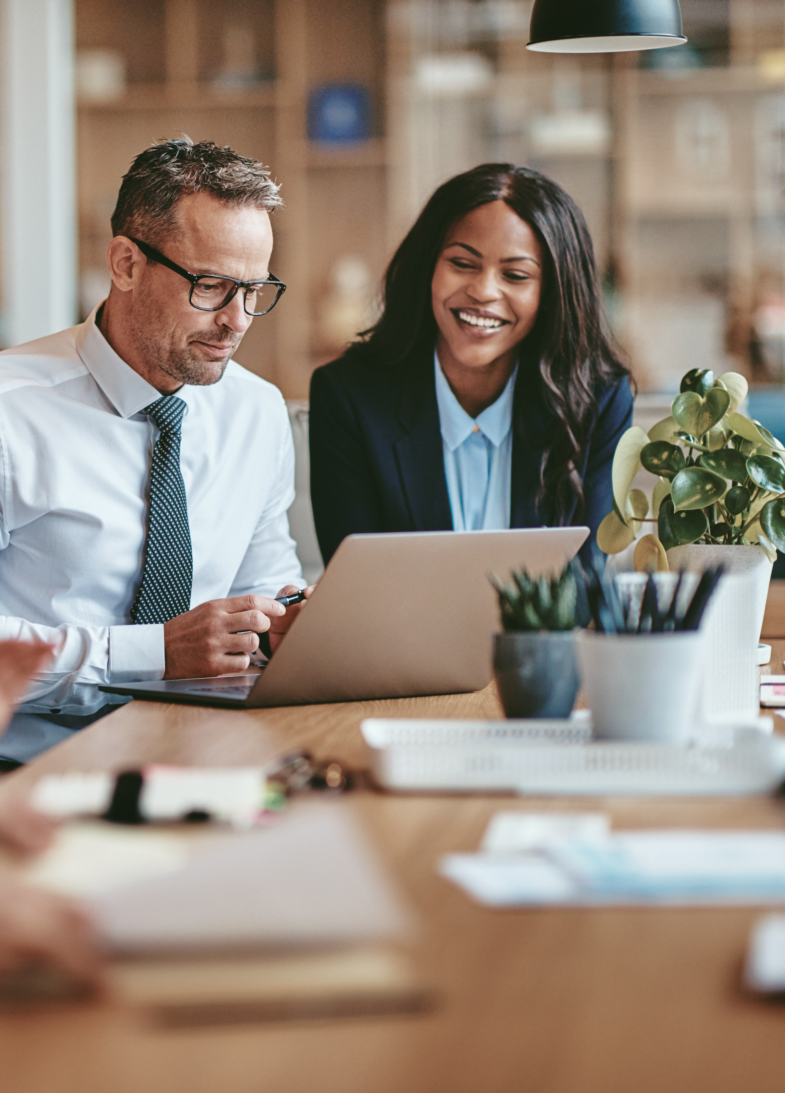 professionals looking at financial strategy laptop